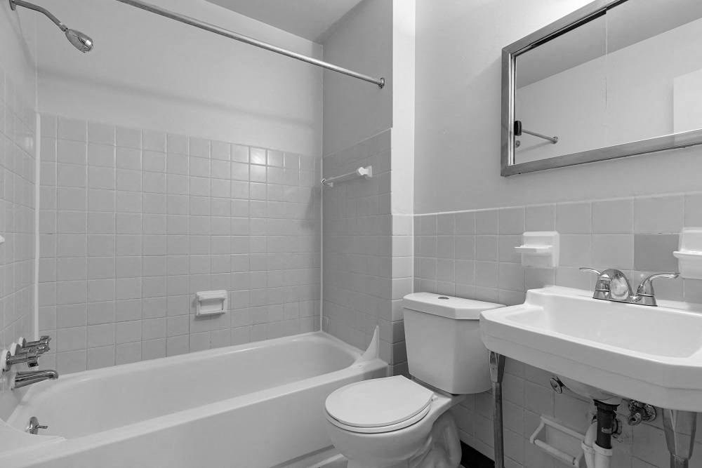 a bathroom with a sink toilet and a bath tub