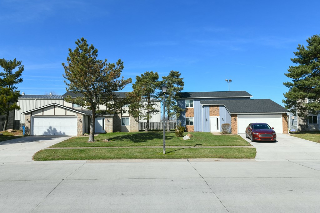 a house with a red car parked in front of it