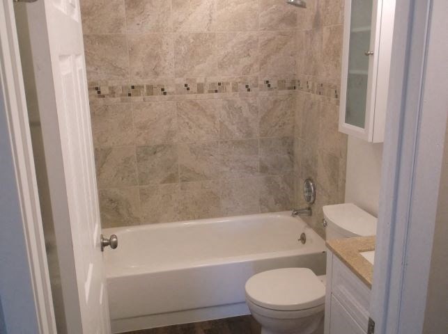 a bathroom with a toilet and a bath tub