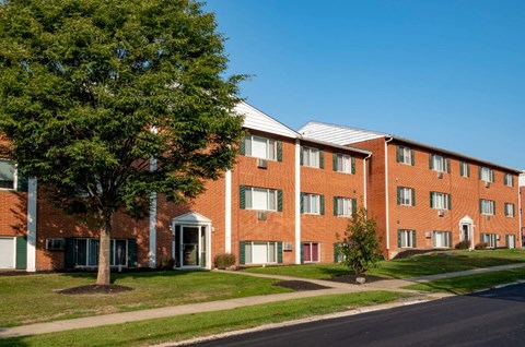 a brick building with a tree in front of it
