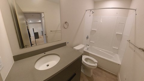 A bathroom with a sink, toilet and bathtub.