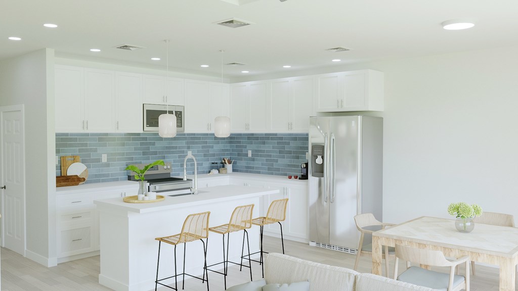 A kitchen with a blue backsplash and white cabinets.