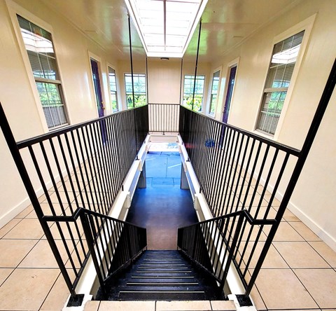 a view down the stairs of a building with windows
