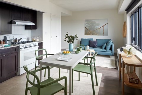 A modern kitchen with a dining table and chairs.