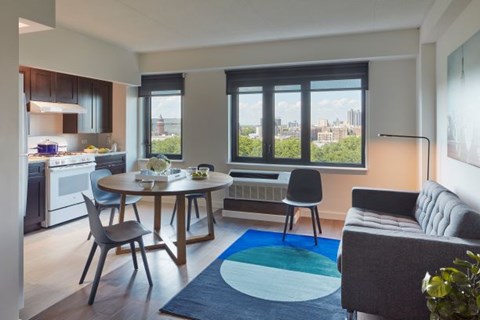 A modern kitchen with a dining table and chairs.