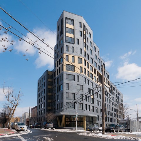 A large grey building with many windows is in the foreground.