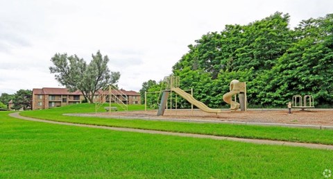 a playground with a slide in a park