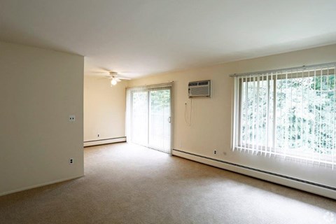 an empty living room with a large window