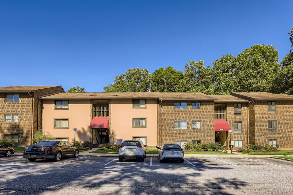 a parking lot in front of an apartment building