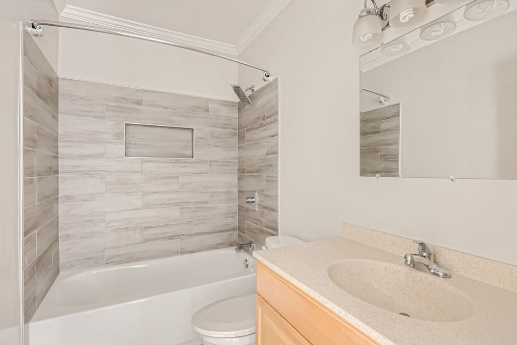 a bathroom with a sink and a tub and a toilet