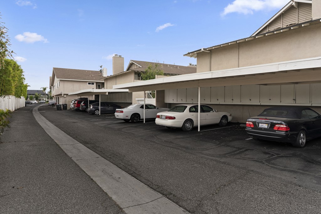 a parking lot with cars parked in front of a building