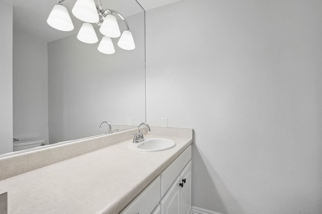 an empty bathroom with a sink and a mirror
