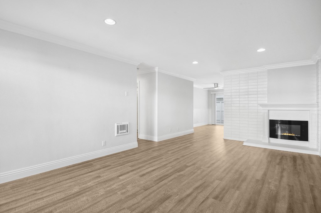 a living room with a fireplace and white walls