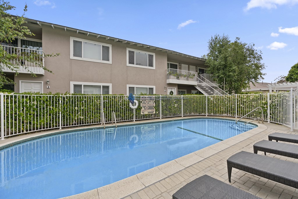 a swimming pool in front of an apartment building
