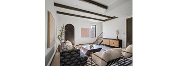 A living room with a black and white striped couch.