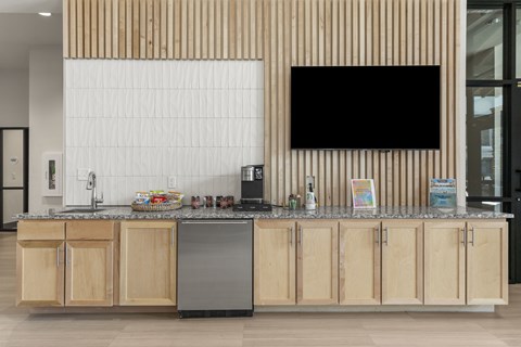 A kitchen with wooden cabinets and a blackboard on the wall.