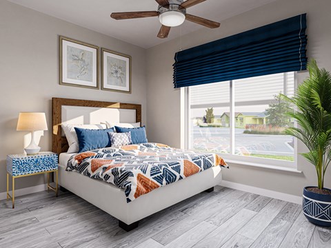 A bedroom with a bed, a ceiling fan, and a window with blinds.