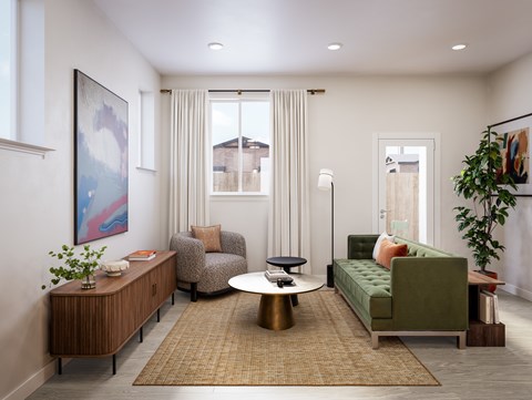 A living room with a green couch, a coffee table, and a painting on the wall.