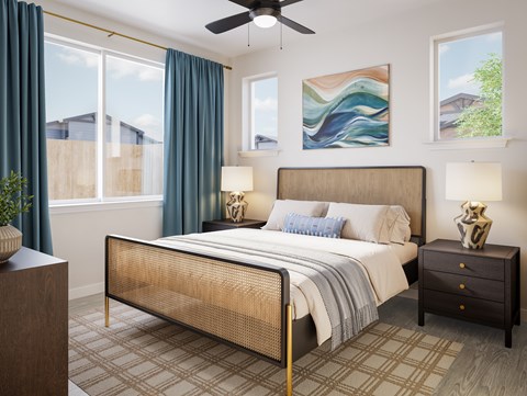 A bedroom with a large bed, a ceiling fan, and a painting on the wall.