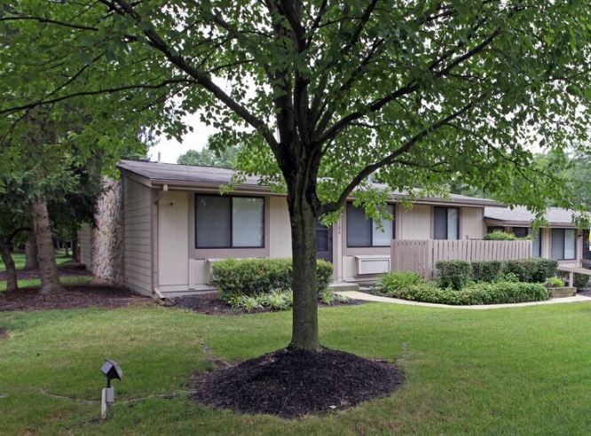 A tree in front of a house.