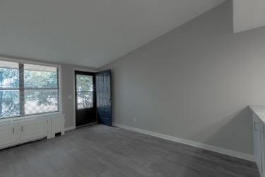 A room with a window and a door.