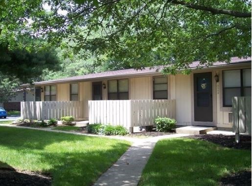 A small building with a fence in front of it.