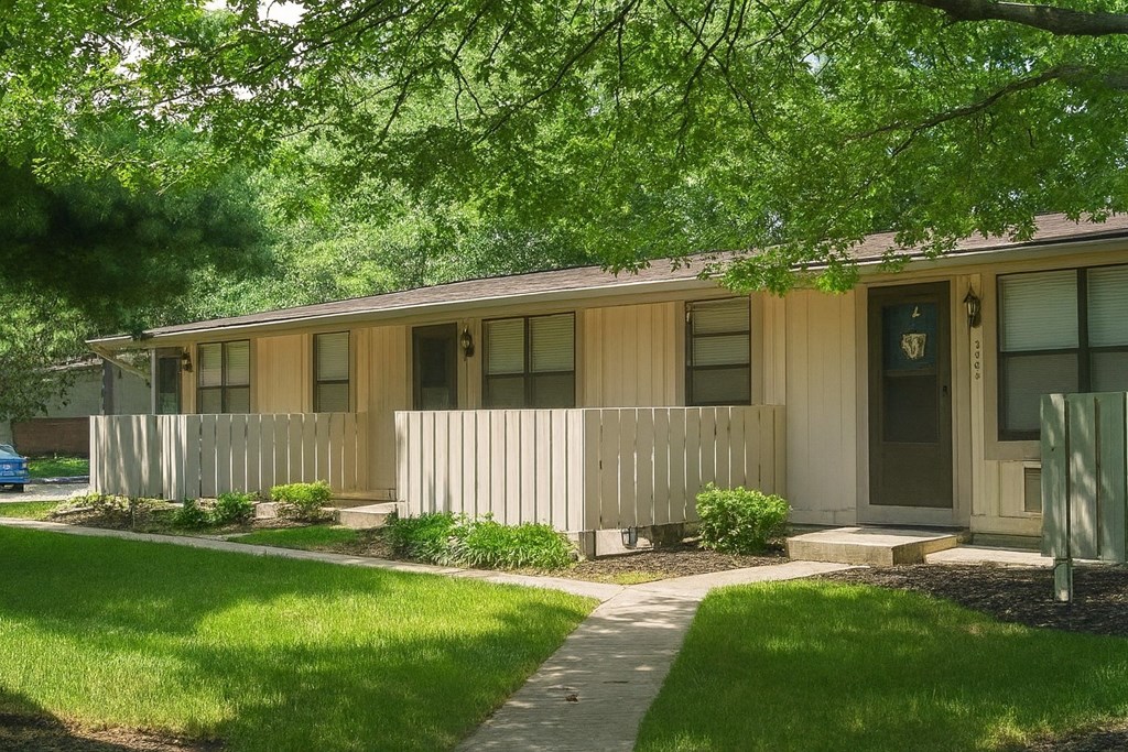 A small house with a brown door and a small porch.
