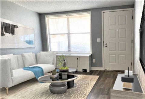 A living room with a white couch and a grey coffee table.