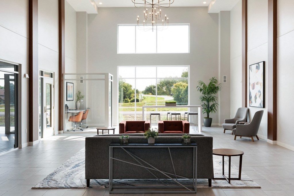 a large living room with a large window and a table with chairs