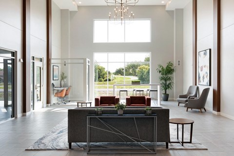 a large living room with a large window and a table with chairs