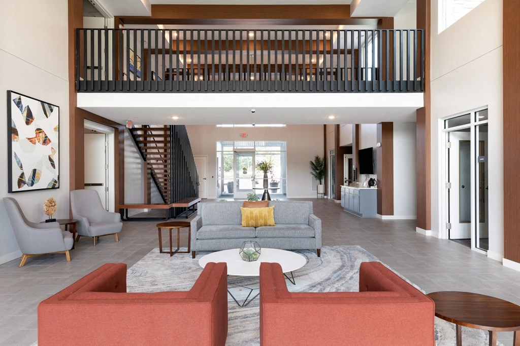 a living room with couches and chairs and a table