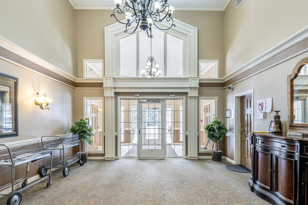 a large hallway with a chandelier and a glass door