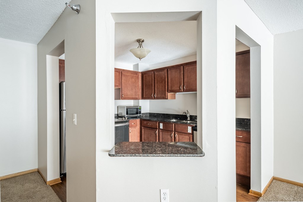 a kitchen with wood cabinets and granite countertops