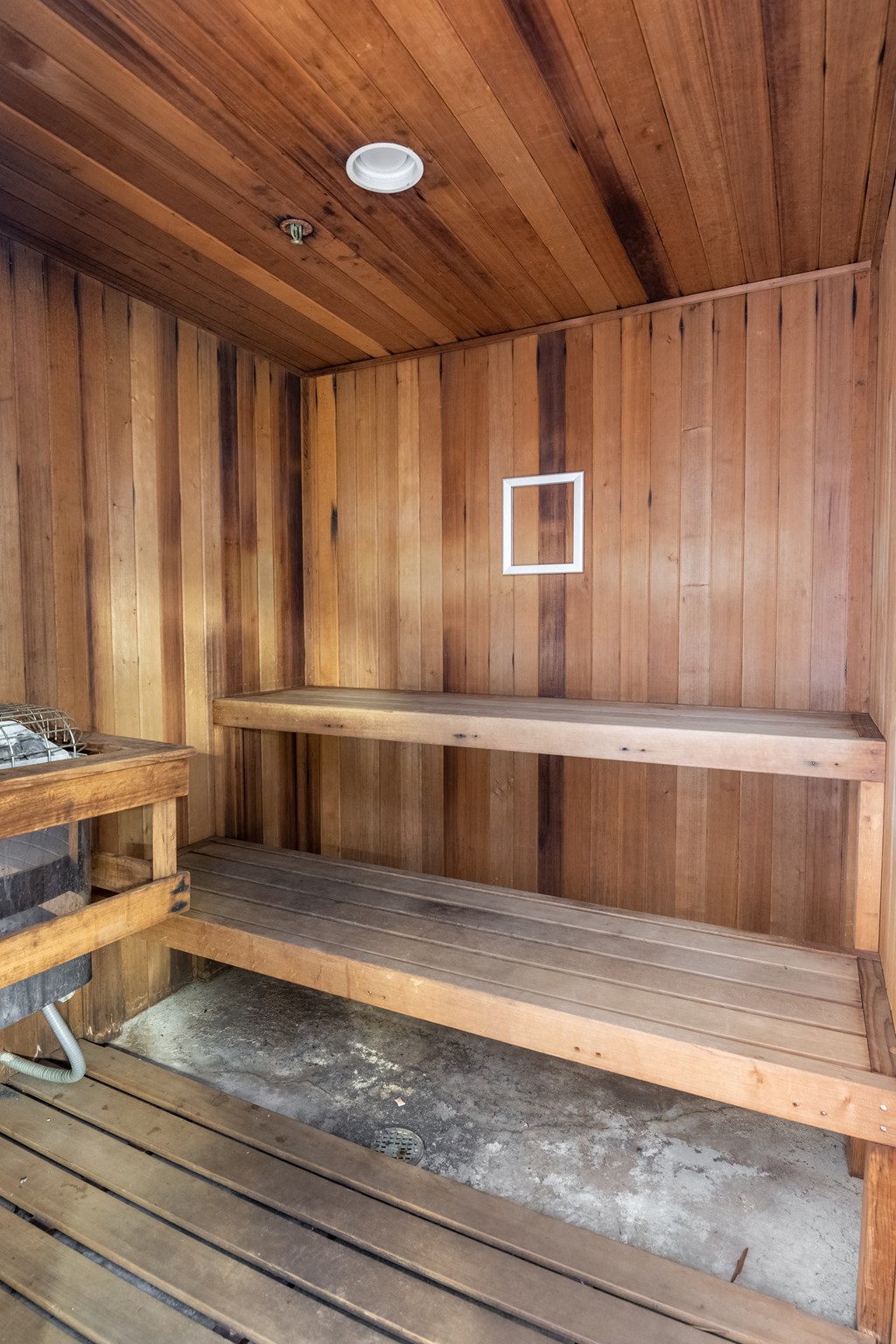 an empty sauna with wooden walls and floors