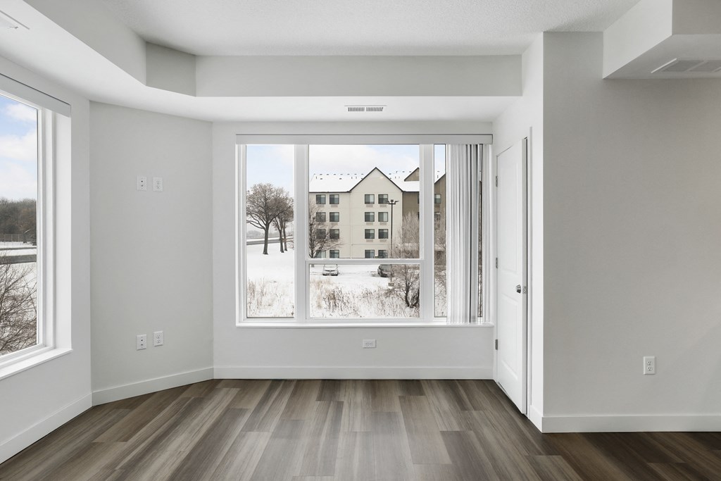 an empty living room with a large window