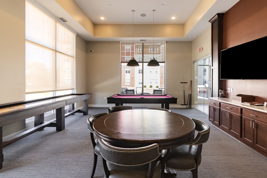 a room with a table and chairs and a ping pong table