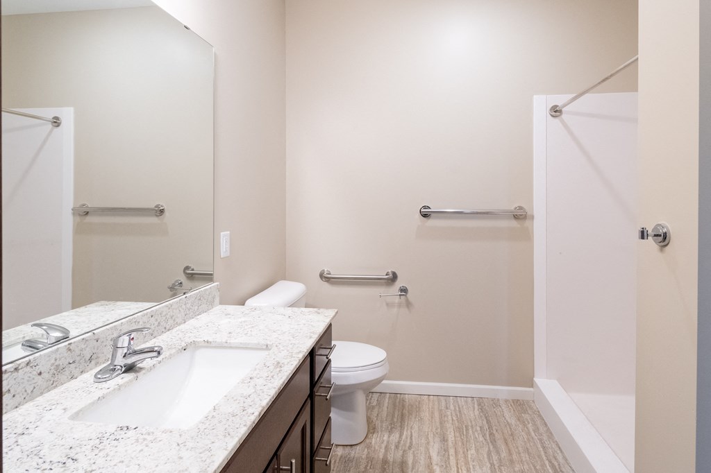 a bathroom with a toilet sink and shower