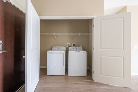 a washer and dryer in the laundry room of a manufactured home at The Winslow 62+ Apartments, West St Paul, MN