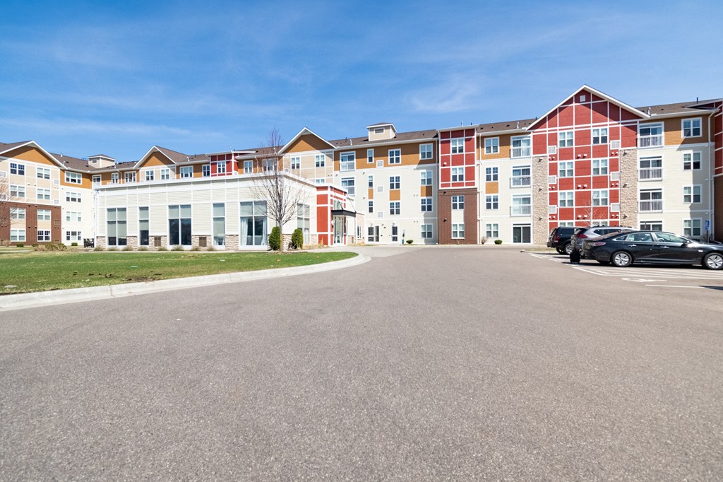 an empty parking lot in front of an apartment complex
