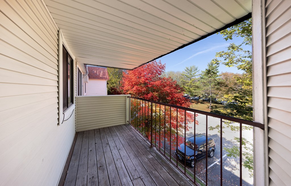 a porch with a car parked on the side of a house