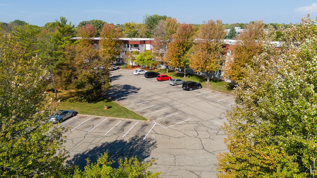 an aerial view of a parking lot with trees
