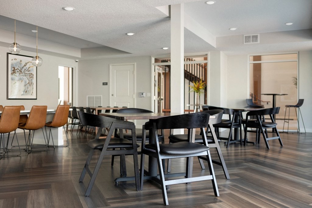 a dining room with a table and chairs in a large room