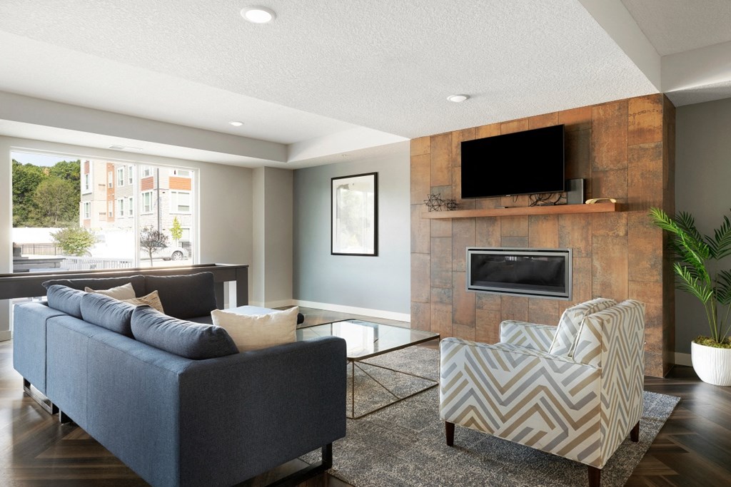 a living room with a blue couch and a fireplace