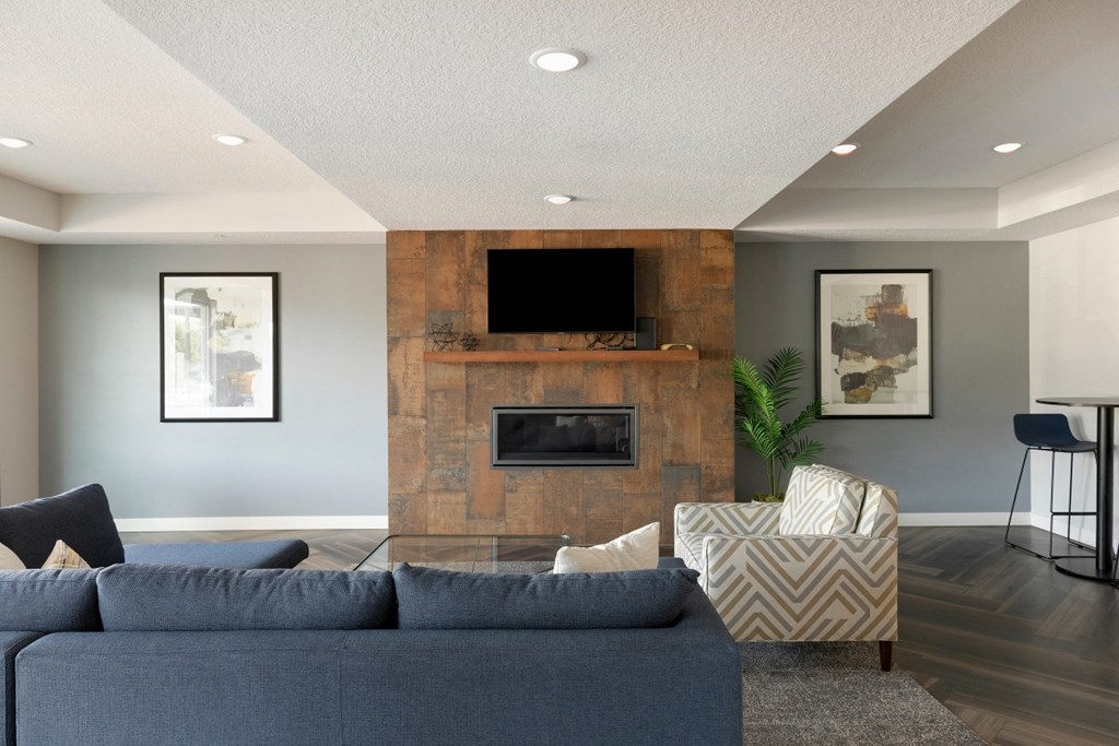 a living room with a fireplace and a blue couch