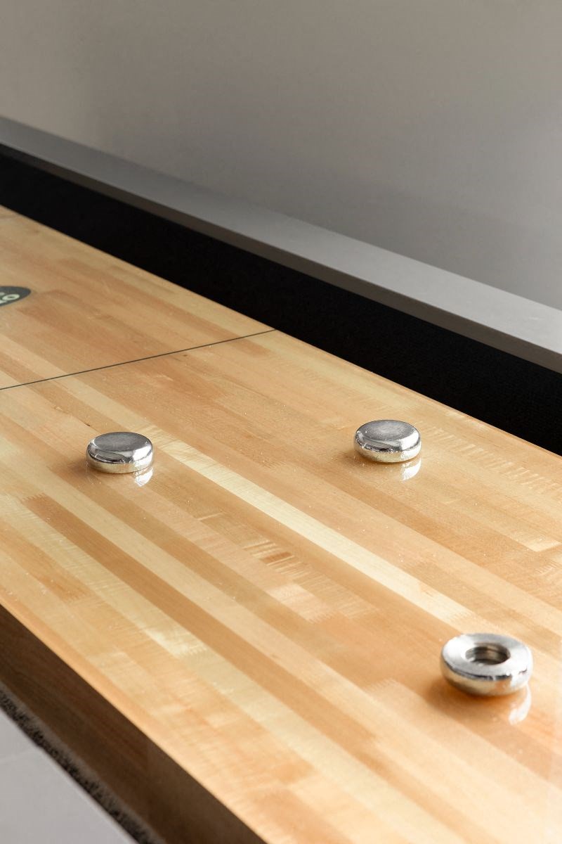 a close up of a wooden table with round handles