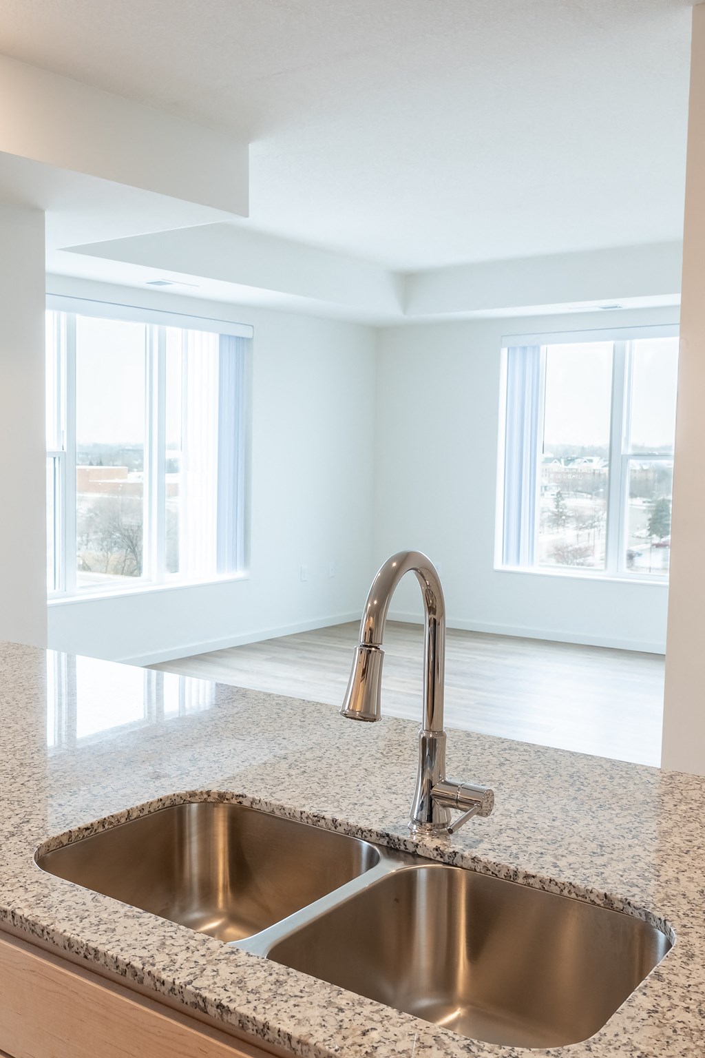 an empty kitchen with a sink and a window