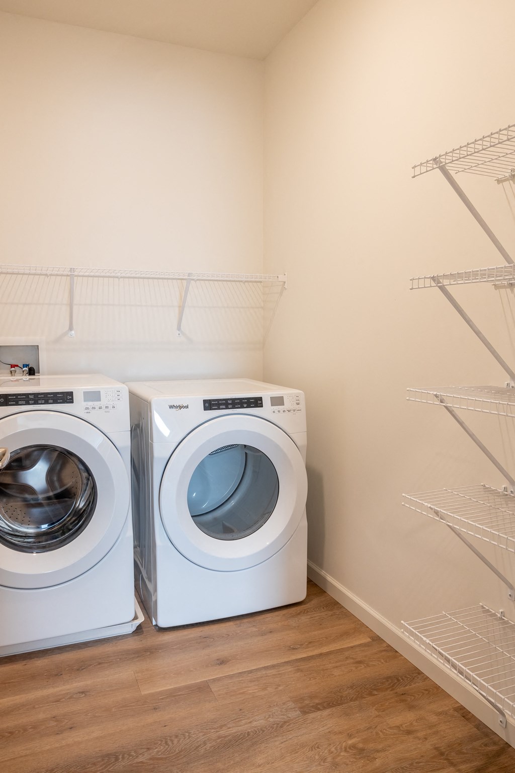 two washing machines in a laundry room with white walls