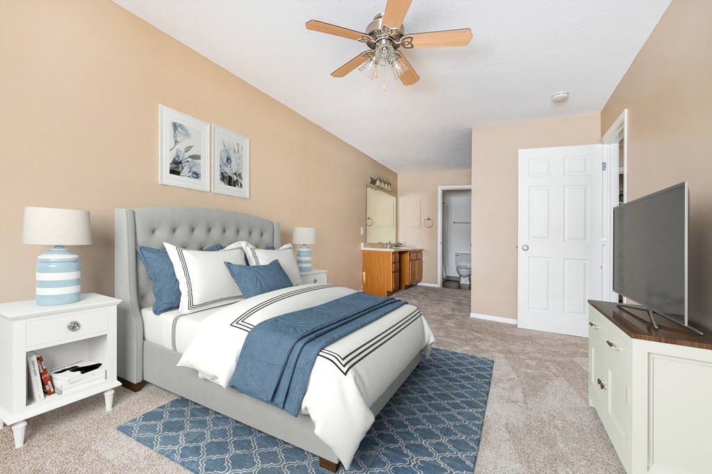 a bedroom with a bed and a ceiling fan