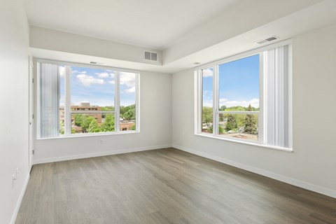 A room with a view of the outdoors through large windows at Sonder Point 50+ Apartments, Brooklyn Center, Minnesota