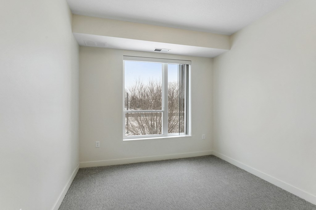an empty living room with a large window